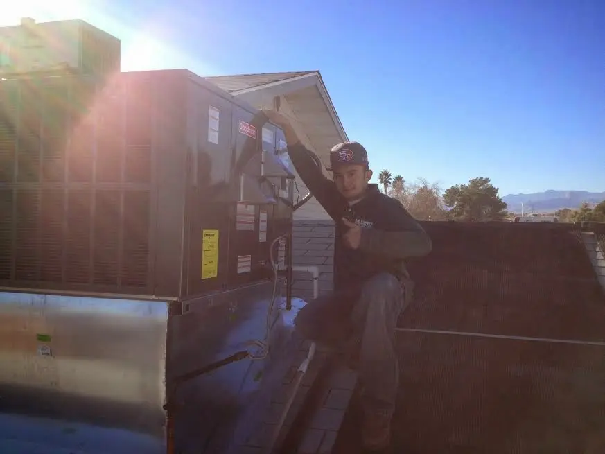 HVAC technician performing AC Tune-Up on a rooftop unit in Silver Springs